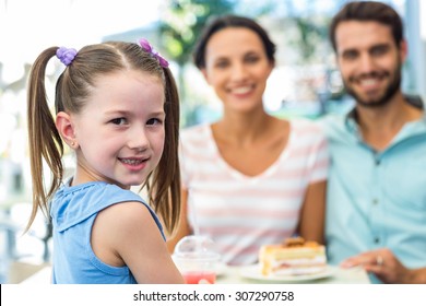 Portrait Of A Family Eating At The Restaurant On A Sunny Day