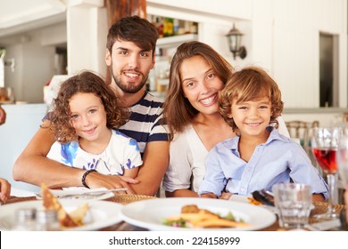 Portrait Of Family Enjoying Meal In Restaurant