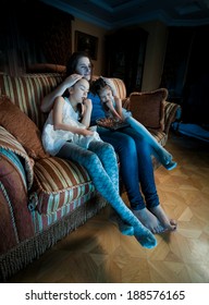 Portrait Of Family Fell Asleep On Sofa While Watching TV At Night