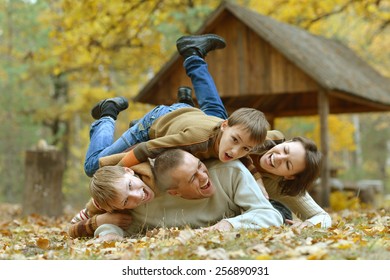Portrait of a family of four in autumn forest