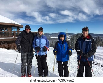 Portrait Of Family Of Four On Ski Vacation At Ski Resort In Angel Fire, New Mexico.