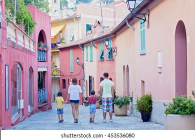 Portrait Of Family Of Four, Walking On The Streets Of Villefranche, Nice, France