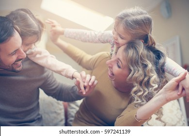 Portrait Of Family Having Fun In The Living Room.