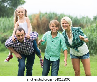 Portrait of family with kids enjoying vacation in village