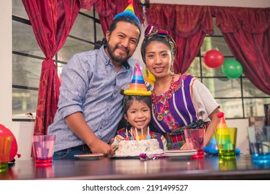 Portrait Of A Family Looking At The Camera At A Birthday Party.
Latin Family Celebrating At Home. Hispanic Family Celebrating A Birthday.