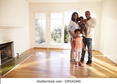 Portrait Of Family In New Home On Moving Day