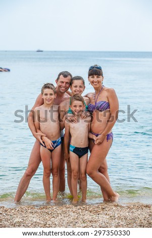 Portrait of a family on the beach in summer