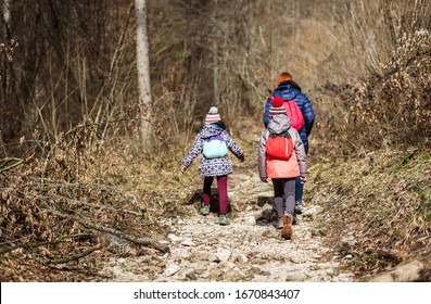 Portrait Of Family On Hiking Forest Trip With Hiking Clothes. Winter Portrait Of Family In Family Hike And Forest, Active Family, Parents And Children Mountaineering In The Nature.