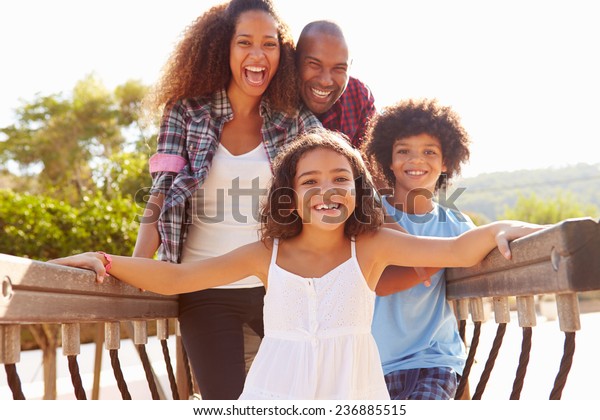 Portrait Of Family\
On Playground Climbing\
Frame