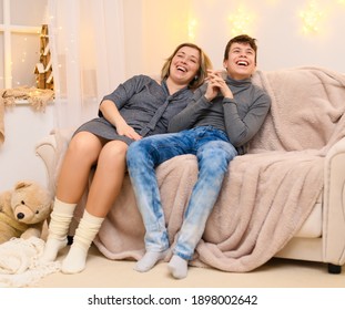 portrait of a family sitting on a sofa at home. - Shutterstock ID 1898002642