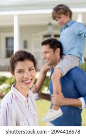 Portrait Family Smiling Outside House