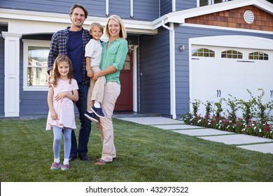 Portrait Of Family Standing Outside House