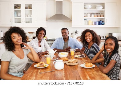 Portrait Of Family With Teenage Children Eating Breakfast