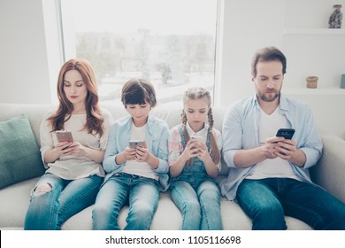 Portrait Of Family With Two Kids Holding Smart Phones Having Electronic Devices In Hands Texting Sms Using Wi-fi 3G Internet Checking Email Searching Contact. Apps Concept