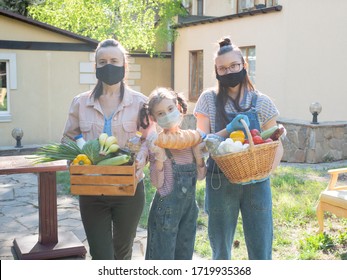 Portrait Of A Family Of Volunteers In Protective Medical Masks Holding Food Packages For Those In Need.