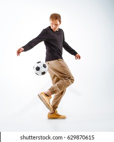 A Portrait Of A Fan With Ball On Gray Studio Background. Freestile