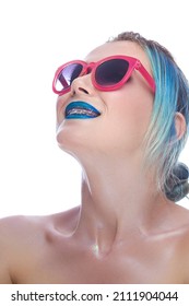 Portrait Of Fancy Caucasian Female With Silky Skin And Teeth Brackets Looking Upwards While Wearing Red Sunglasses As Dental Healthcare Ideas. Vertical Shot