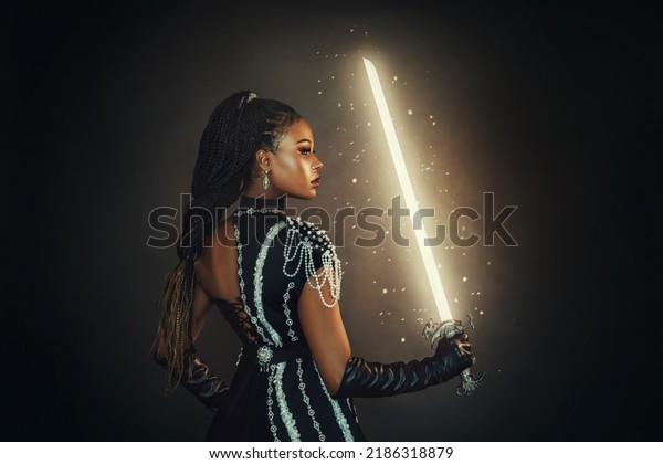 Portrait fantasy african american woman warrior\
holding magic weapon glowing sword weapon in hand. Dark queen girl\
in black military dress. Gothic lady elf fairy magician. Sexy\
warrior princess face
