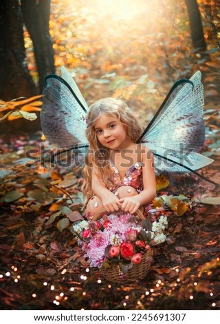 Portrait fantasy fairy little girl, pixie wings creative costume holds basket of flowers bouquet in hands. happy angel butterfly smiling face, elf princess. Magic light autumn trees. Pink dress