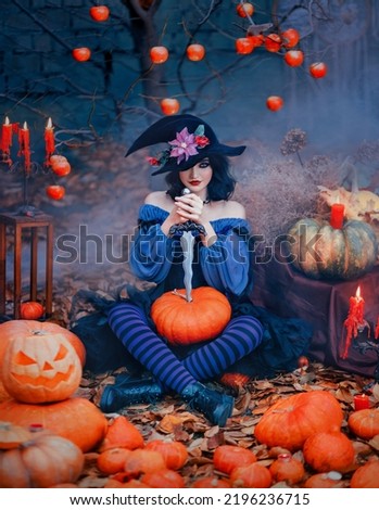Portrait fantasy happy woman witch holding dagger knife ready to carve pumpkin for halloween holiday. Cheerful girl creative costume black purple dress cone hat. Smiling face art makeup. autumn