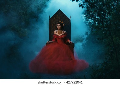 POrtrait Fantasy woman dark evil queen vampire sitting on luxurious medieval throne, dark gothic. Girl Princess in red dress , vampire  creative design. outdoor night forest fog smoke tree. fairy face