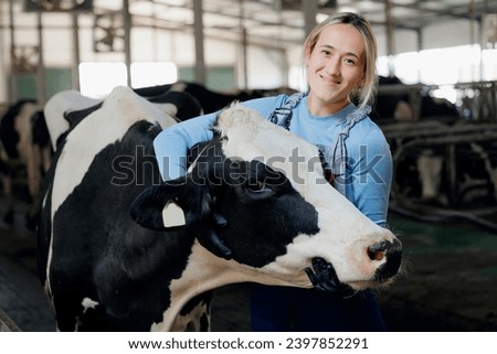 Portrait Farmer Happy young woman hugging cow, concept veterinary health care. Concept agriculture cattle livestock farming industry.