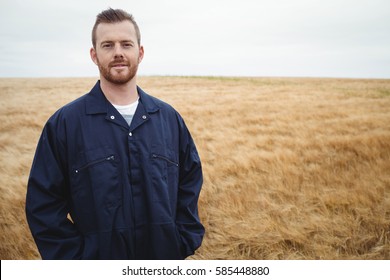 Portrait of farmer standing in the field on a sunny day