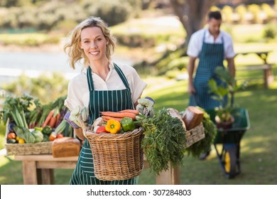 Portrait of a farmer woman holding a vegetable basket