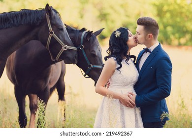 Portrait of a fashion bride and groom with horses