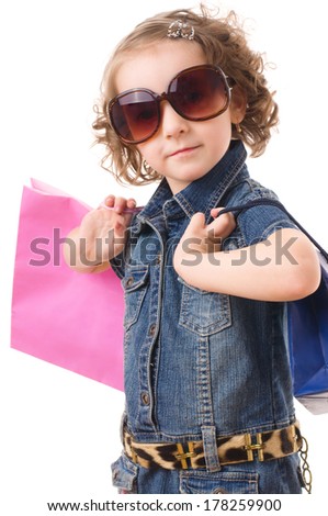 Portrait of the fashion shopping little girl with shopping bags, isolated over white
