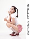 Portrait fashion of young Asian beauty woman model pigtail hairstyle with Korean beauty style makeup perfect clean skin on isolated white background. Lolipop girl concept.