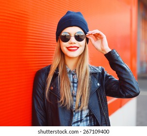 Portrait of fashionable smiling woman wearing a rock black style having fun outdoors in the city