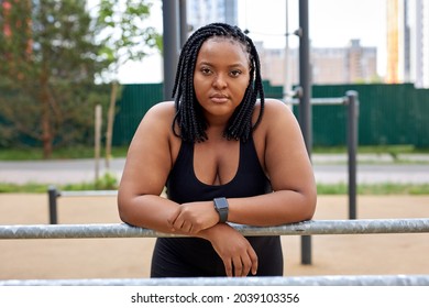 Portrait Of Fat Afro American Woman Confidently Looking At Camera After Sport Workout. Serious Lady In Black Tracksuit Having Rest, Taking Break After Exercises. Copy Space. People Lifestyle Concept - Powered by Shutterstock