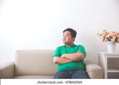 Portrait of Fat asian man thinking and looking up to copyspace