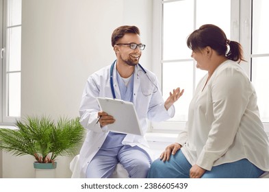 Portrait of fat overweight female patient in medical office listening to a friendly doctor holding report file with appointment and giving consultation a woman during medical examination in clinic. - Powered by Shutterstock