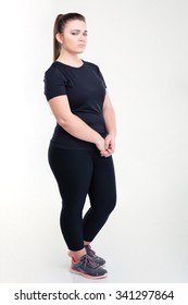 Portrait Of A Fat Sad Woman In Sportswear Standing Isolated On A White Background