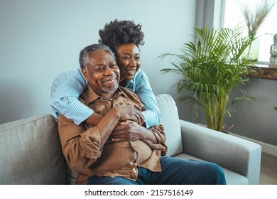 Portrait Of Father And Daughter Laughing And Being Happy.  Daughter With Her Arm Around Her Father Both Smiling. Smiling Young Woman Enjoying Talking To Happy Old Father. 