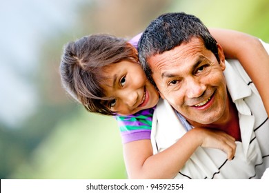 Portrait of a father and his daughter having fun outdoors