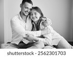 Portrait of father and teenage daughter hugging each other at home. Cute moment of dad and child in glasses showing their love to each other. Lovely spending time with family. Black and white image.