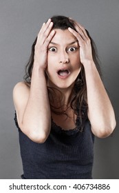portrait of fear - amazed young woman with hands holding her head expressing jaw dropping surprise and consternation, gloomy grey background studio - Shutterstock ID 406734886