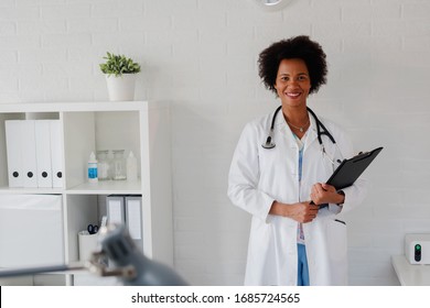 Portrait Of Female African American Doctor Standing In Her Office At Clinic