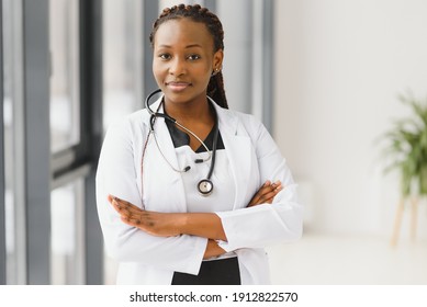 Portrait Of Female African American Doctor Standing In Her Office At Clinic