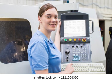 Portrait Of Female Apprentice Engineer Operating CNC Machine In Factory - Powered by Shutterstock