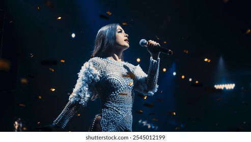 Portrait of a Female Artist Passionately Performing an Emotional Song on Stage. Musician Wearing a Creative Outfit, Holding a Microphone, Glittering Confetti Falling Down, Reflecting Dramatic Lights - Powered by Shutterstock