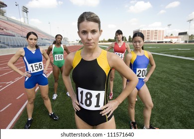 Portrait Of Female Athlete Standing On Track And Field