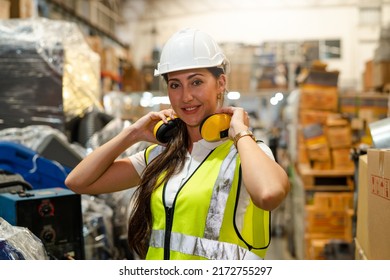 Portrait Of Female Automation Engineer Smiling Hold Earphones In Industrial Factory.