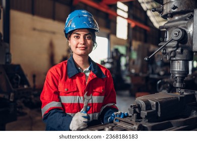 Portrait of female automation engineer standing in modern industrial factory and looking camera in industrial factory. - Powered by Shutterstock