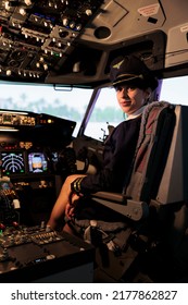 Portrait Of Female Aviator Sitting In Airplane Cabin To Fly Aircraft, Pushing Dashboard Command Buttons And Power Switch. Flying Plane With Control Panel Lever And Radar Navigation Windscreen.