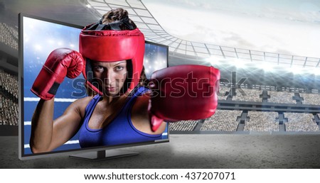 Portrait of female boxer with gloves and headgear against composite image of ring ropes