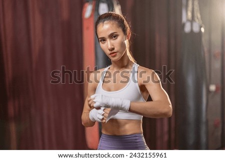 Portrait of a female boxing enthusiast in the ring, demonstrating consistent dedication and ability in a struggle for success, aspiring to become a professional athlete.